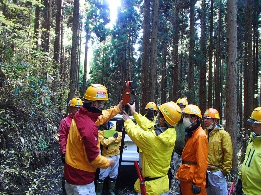 レーザースキャナー機材の操作法を現地で複数の職員等が確認している写真